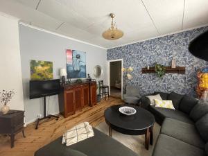 a living room with a couch and a tv at Granbo station in Granbo