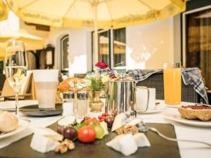 a table with plates of food and wine glasses at Hotel Finkenbergerhof in Finkenberg