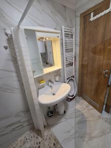 a white bathroom with a sink and a mirror at Luxury flat Boka Nest in Dobrota