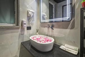 a bathroom with a bath tub covered in sprinkles at Hotel Stay Well Dx in New Delhi
