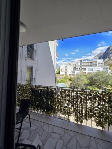 a view from a balcony of a building with a chair at Luxury flat Boka Nest in Dobrota