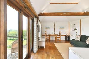 a living room with a couch and a table at Acorn Barn in Ashford