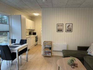 a living room with a couch and a table at Rødhus Camping in Pandrup