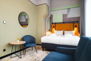 a hotel room with a bed and a table and a chair at Focus Hotel Premium Olsztyn in Olsztyn +51 photos