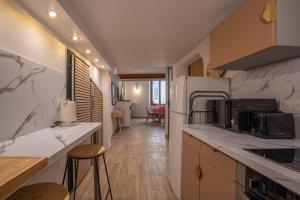 a kitchen with white marble counter tops and a hallway at La vie en rose in Grasse