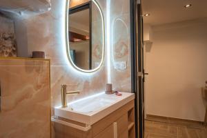 a bathroom with a sink and a mirror at La vie en rose in Grasse