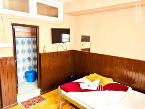 a room with a couch and a television in a room at PEMA Hotel VSTM in Darjeeling