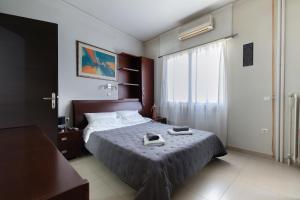 a bedroom with a bed and a window at Seaside Apartment with a great view in Chalkida in Chalkida