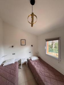 two beds in a room with a window at Au Pays de Cocagne in Nyons +29 photos