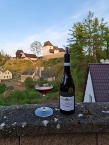 a bottle of wine sitting next to a glass at Chata Seeberg in Poustka