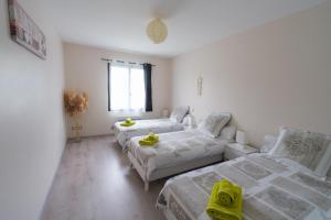 a bedroom with two beds and a couch in it at Fleur Du Ciel Vendée in Challans +6 photos