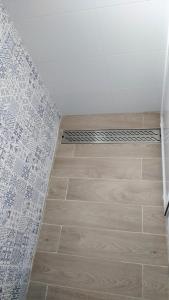 a bathroom with a shower and a tile floor at Relax e Mare a Bellaria in Bellaria-Igea Marina +5 photos