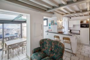 a kitchen and dining room with a table and chairs at Maison charmante près de Sainte Catherine in Honfleur +16 photos