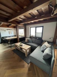 a living room with a couch and a table at Landhaus Osttirol in Iselsberg