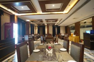 a dining room with a long table and chairs at Neel Clarks Inn Express in Agra