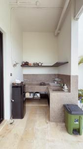 a kitchen with a sink and a counter top at Tris Villa 3 in Bumbang