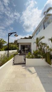a white house with a staircase and plants at Tris Villa 3 in Bumbang +5 photos