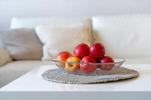 a glass bowl of apples on a table at Strandburg Ostseeblick Scharbeutz in Scharbeutz
