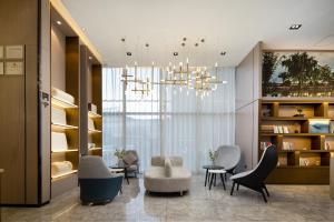 a living room with chairs and a chandelier at Atour Hotel Hefei Changjiang Road Zhixincheng Annongda in Hefei