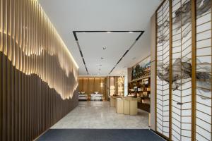 a lobby of a hotel with a large wall of wood at Atour Hotel Hefei Changjiang Road Zhixincheng Annongda in Hefei