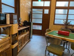 a room with a ping pong table and a desk at Lane 82 Homestay in Chiayi City
