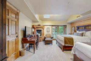 a bedroom with a bed and a desk with a piano at Hotel studio with views fireplace & close to everything in Park City