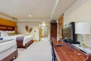 a hotel room with a bed and a tv and a bedroom at Hotel studio with views fireplace & close to everything in Park City