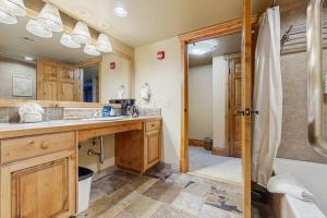 a bathroom with a shower and a sink and a tub at Hotel studio with views fireplace & close to everything in Park City