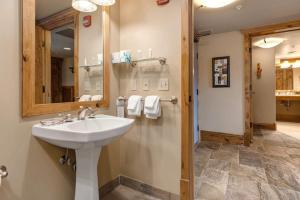 a bathroom with a sink and a mirror at Epic view condo with fireplaces & close to everything in Park City