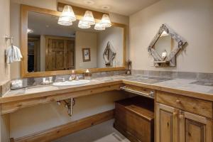 a bathroom with a sink and a large mirror at Epic view condo with fireplaces & close to everything in Park City