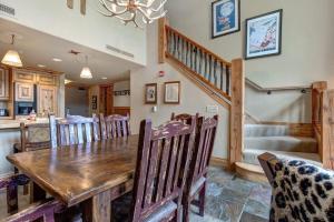 a dining room with a wooden table and chairs at Stunning view condo with fireplace & close to everything in Park City +17 photos