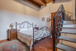 a bedroom with a bed and a staircase at Agriturismo i Due Casini in Riano