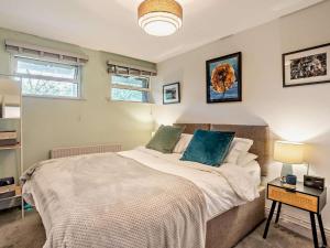 a bedroom with a large bed with blue pillows at 2 Bed in Brecon oc-bn140 in Brecon