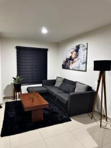 a living room with a couch and a coffee table at Casa en Privada! in Culiacán