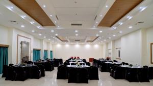 a banquet hall with tables and chairs in a room at Hotel Tamilnadu Pandiyan Madurai in Madurai +20 photos