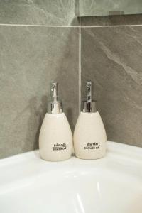 two soap dispensers sitting on top of a bathroom sink at Sunset Garden in Phúc Trì +24 photos