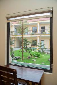 a window view of a garden outside a building at Sunset Garden in Phúc Trì