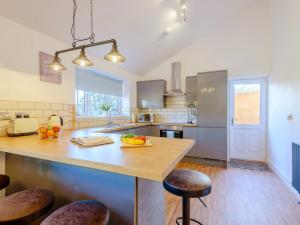 a kitchen with a large wooden island with bar stools at 2 Bed in Bridgnorth oc-77721 in Highley