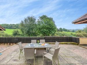 a patio with a table and chairs and a fence at 3 Bed in Bridgnorth oc-thfis in Highley