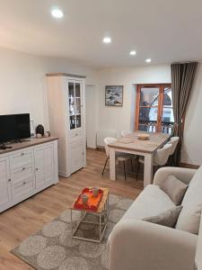 a living room with a couch and a table at Centre Chambéry - Parking gratuit - tout inclus in Chambéry