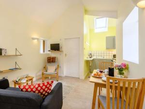 a living room with a couch and a table at 1 Bed in Clyro oc-86975 in Clyro