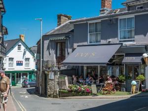 people sitting outside of a restaurant on a street at 1 Bed in Clyro oc-86975 in Clyro +11 photos