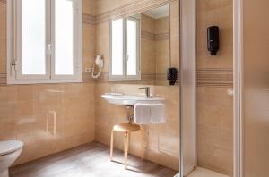 a bathroom with a sink and a toilet at Hotel Mediodia in Madrid +53 photos