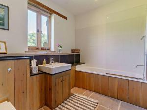 a bathroom with a sink and a bath tub at 2 Bed in Abergavenny oc-66630 in Dorstone +26 photos