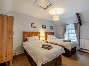 a bedroom with two beds and a window at 2 Bed in Crickhowell oc-bn052 in Llangynidr