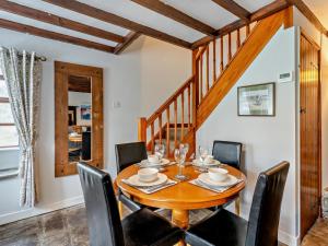 a dining room with a wooden table and chairs at 2 Bed in Crickhowell oc-bn052 in Llangynidr