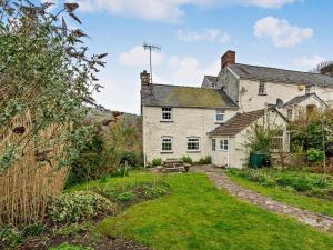 an old house with a garden in front of it at 2 Bed in Crickhowell oc-bn052 in Llangynidr