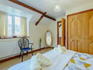 a bedroom with a bed and a chair and a mirror at 3 Bed in Builth Wells oc-52463 in Alltmawr +21 photos