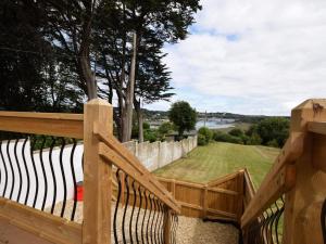 a wooden fence with a view of a yard at 1 Bed in Bideford oc-74817 in Bideford