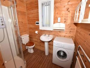 a bathroom with a toilet sink and a washing machine at 3 Bed in Hereford oc-bn141 in Clyro